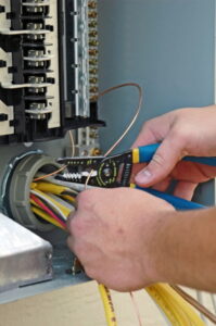 technicians-hands-working-on-wires-in-electrical-panel